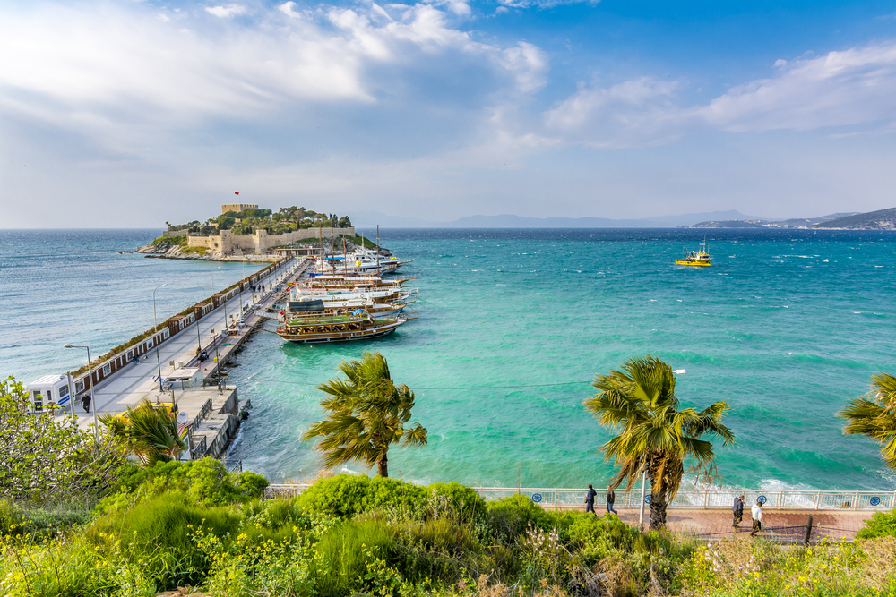 A pier the served as a bridge of a mainland to a small island in Kusadasi, our pick as one of the best areas to stay in the Mediterranean, where small boats are docked.