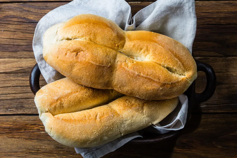 A freshly baked bread placed on a tray with a napkin.