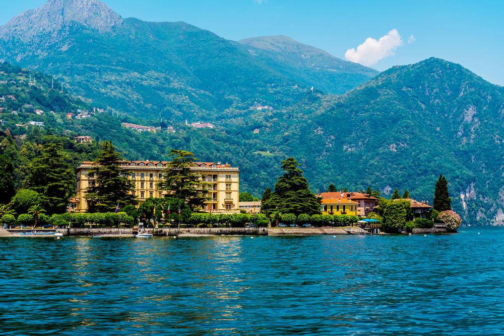 A lake town with a few structure and a background of a tall mountain on Mennagio, a top pick for where to stay in Lake Como