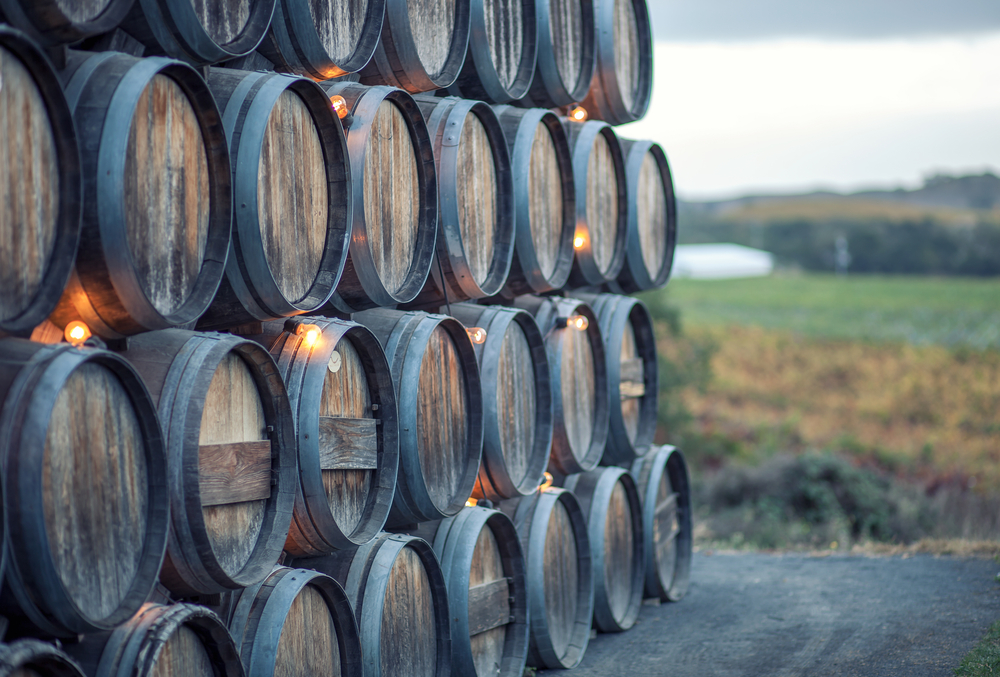 Stacked barrels of beverages during the ageing process, an image for an article about trip cost to Napa Valley.