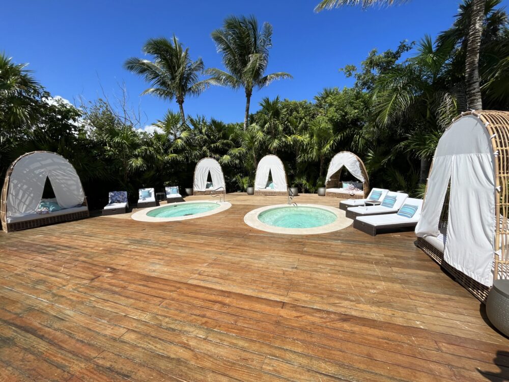Cabanas surrounding the pool deck and warm tubs at the Grand Luxxe pool in Riviera Maya