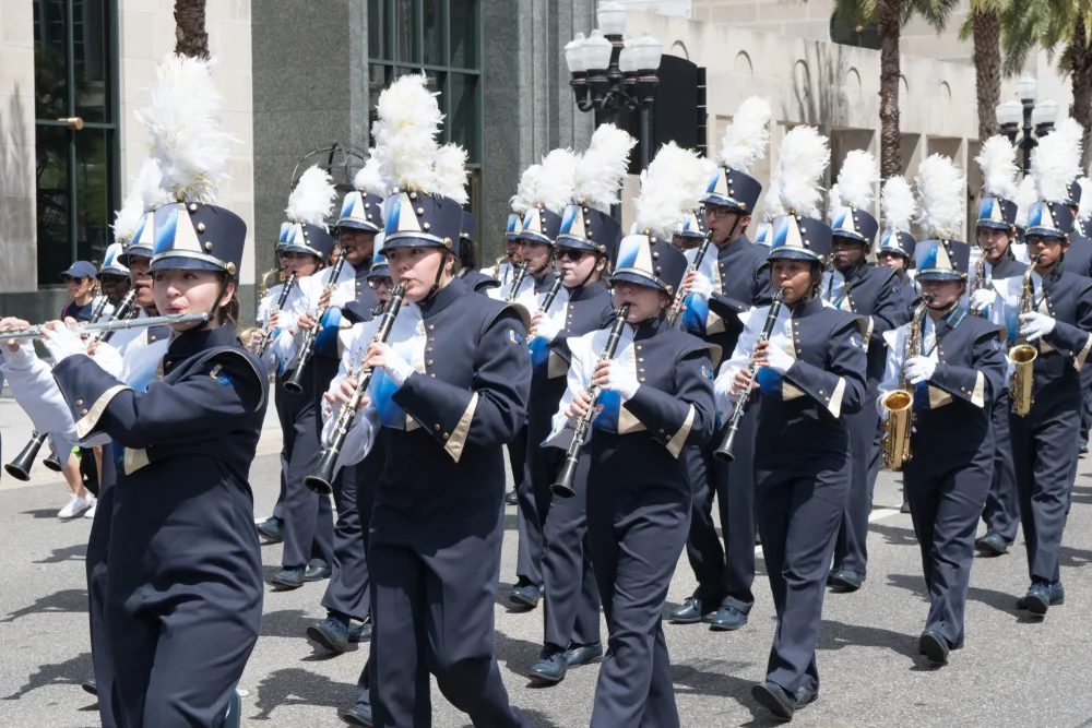 A local band in their uniform playing Clarinets and Trumpets during a festival. 