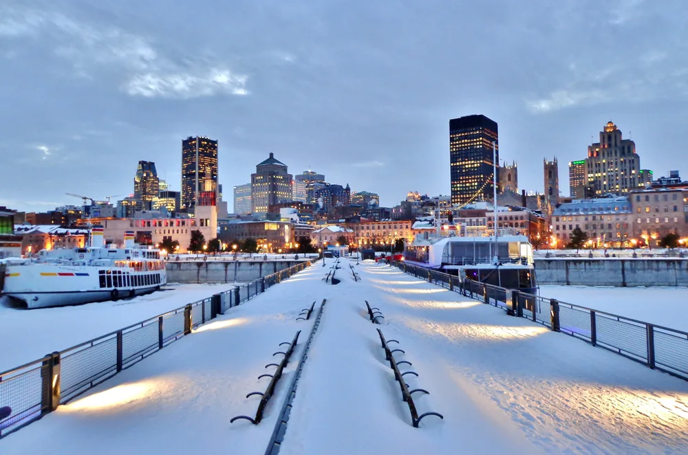 Snow-covered pier with downtown Montreal pictured during the winter, the overall worst time to visit
