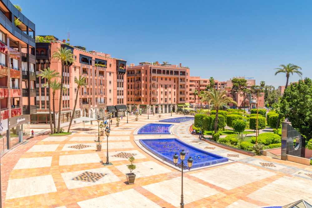A square with small garden area and several shallow ponds in Gueliz, our pic on the best areas to stay in Marrakech, surrounded by buildings. 