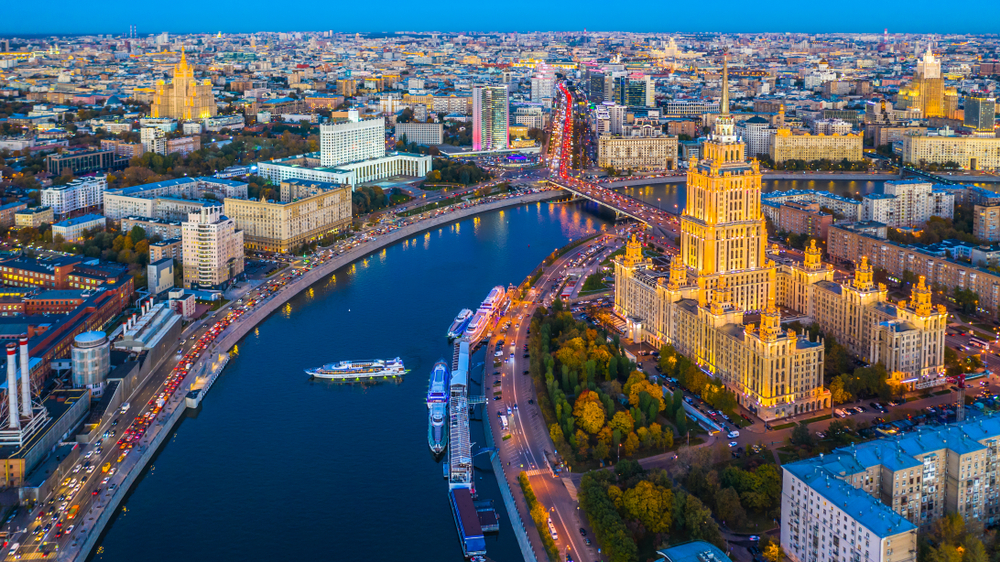 A rich and densely populated city with a wide canal and tall buildings in the Eastern Europe.