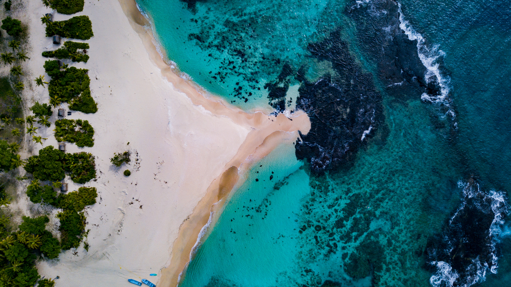 Aerial view of a sandy point on a beach in the Yasawa Islands of Fiji for a guide answering how long flights to Fiji take from the US