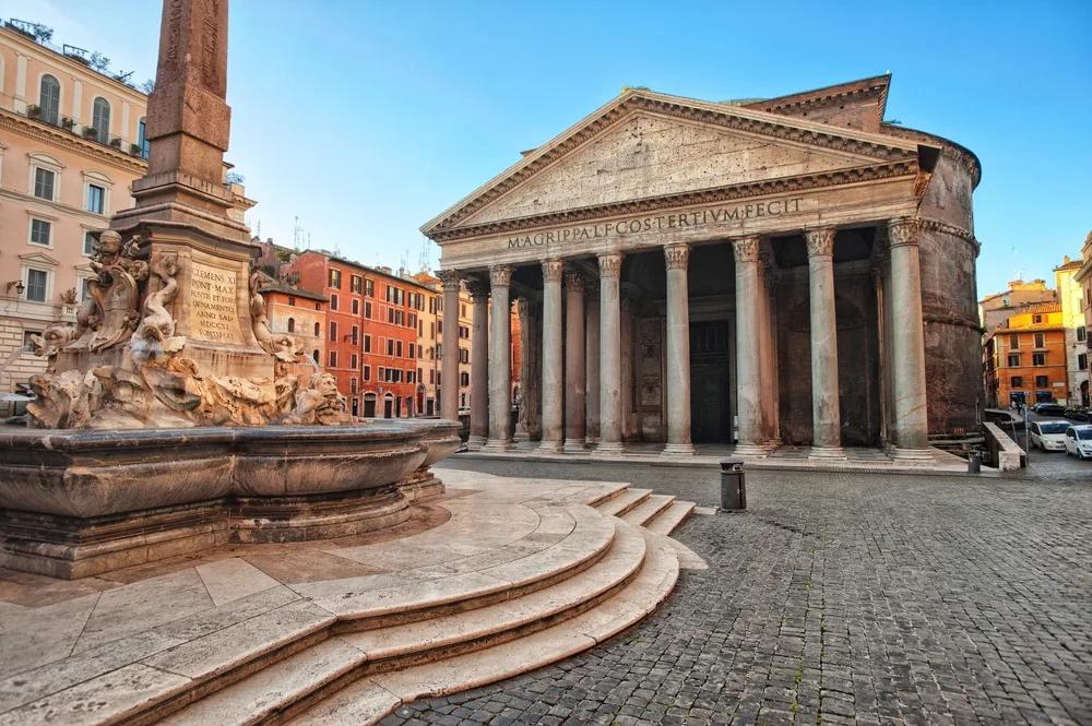 View of the Pantheon in Rome, Italy looking at the curved steps and stone streets for a 2-week European itinerary to major cities