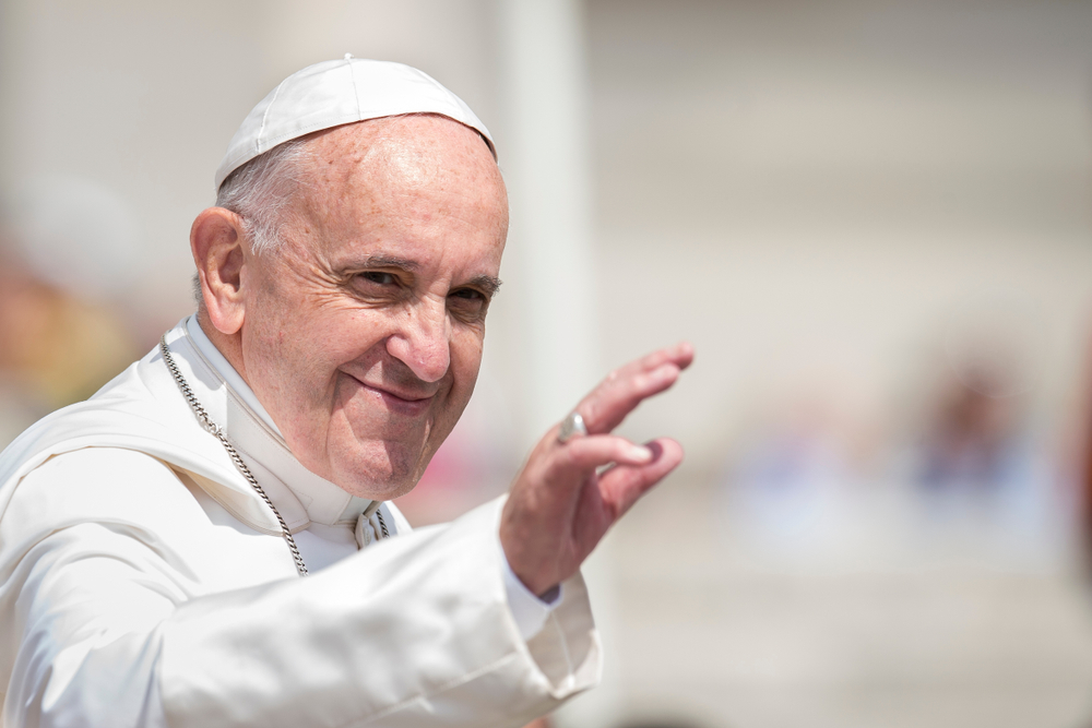 The current Pope Francis gesturing his hand forward. 