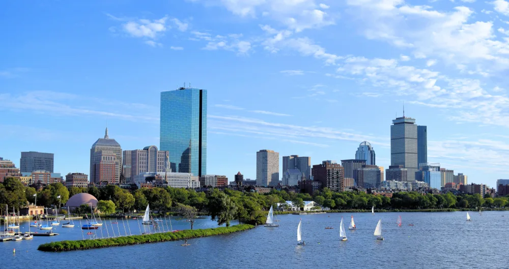 Boston's Back Bay skyline with the Charles River and sailboats in the foreground as one of the stops on a 48-hour weekend Boston itinerary