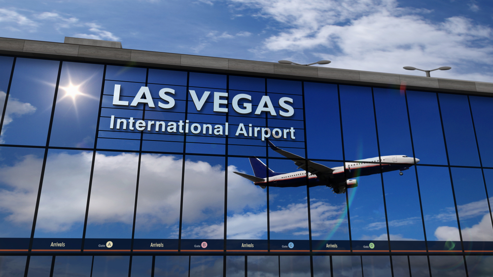 3D rendering of a plane landing at Las Vegas International Airport with reflection in the exterior windows for a guide detailing how long it takes to fly to Vegas