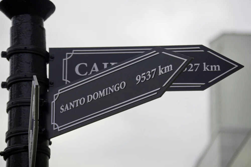 A direction pointer that says Santo Domingo 9,537 km. 