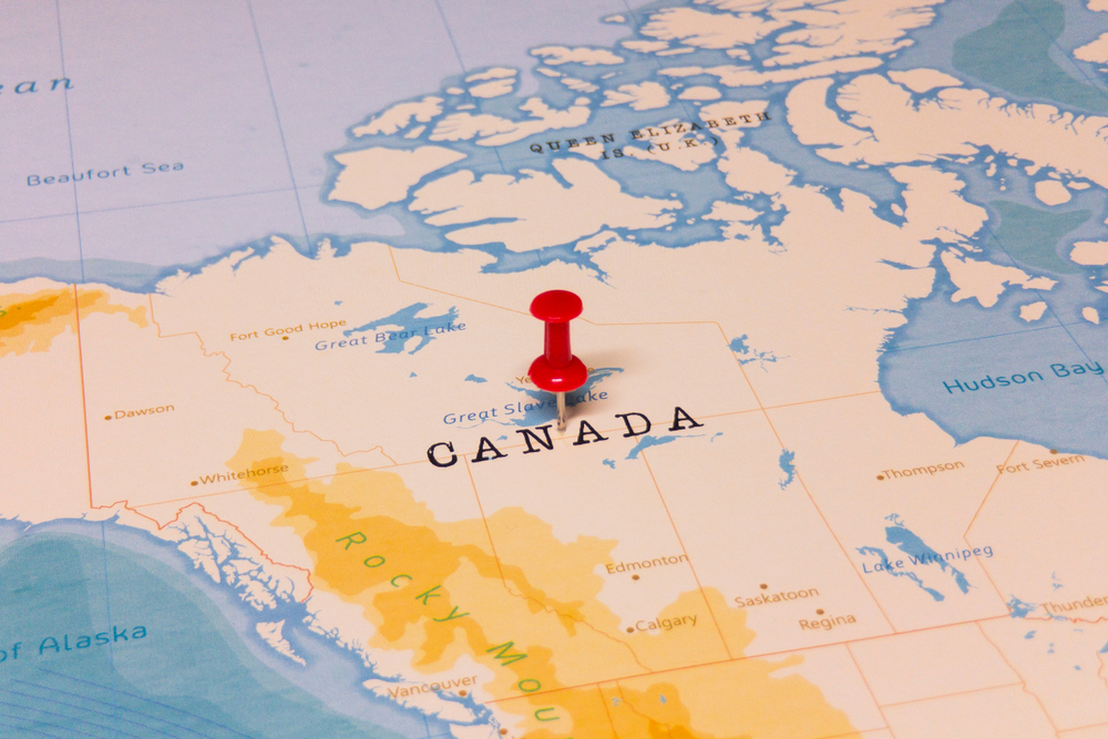 A red pin pinned on a map of Canada.
