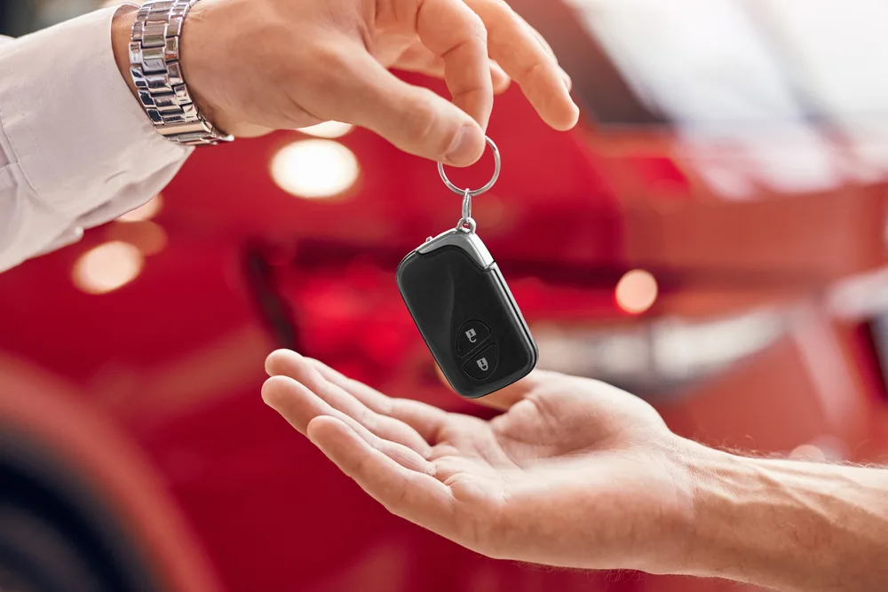 A person receiving a car key. 