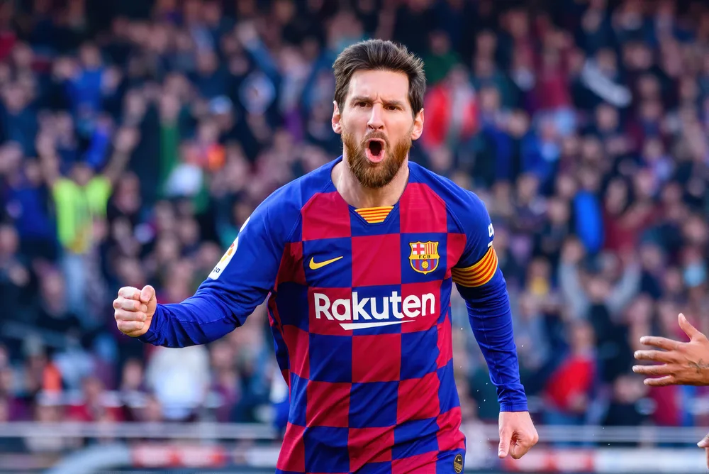 The ever famous football player Lionel Messi celebrating while in game. 