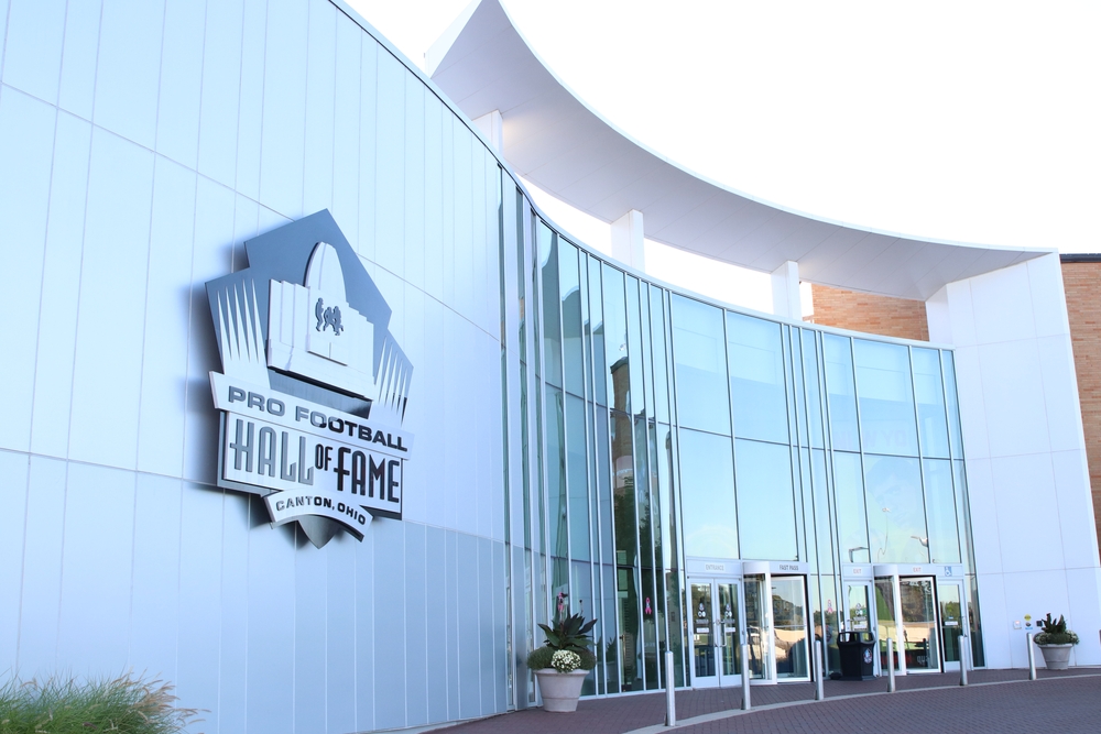 A modern structure that has a sign in front Pro Football Hall of Fame Canton. 