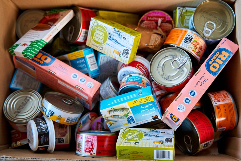 A box of canned goods in various brands to show how help after a hurricane hits as a point of the guide titled when is the hurricane season in the Caribbean.