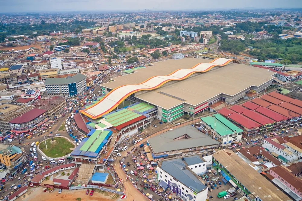 Aerial view on a city where the market area can be seen covering a large area and the traffic around the city can be seen congested. 