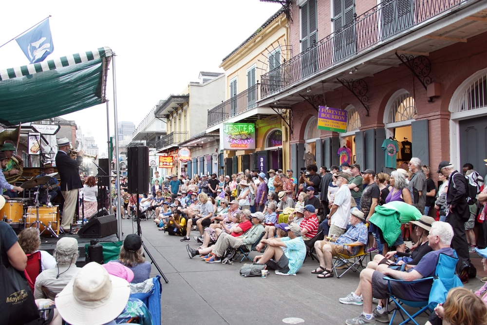 Crowd of people in the French Quarter in New Orleans for a guide to whether or not it's safe to visit