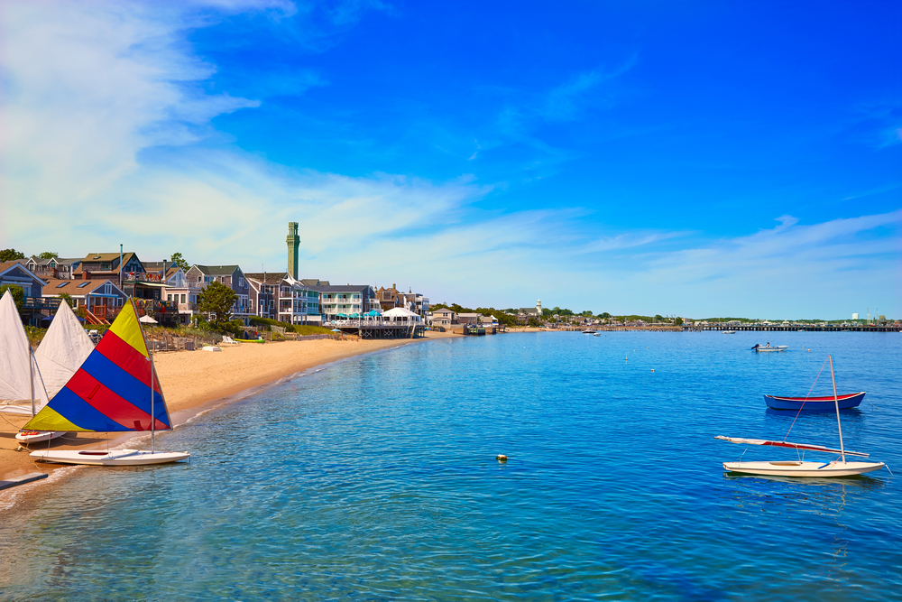Provincetown Beach in Cape Cod shown with sailboats on the shore as the top destination among summer vacation ideas in the US