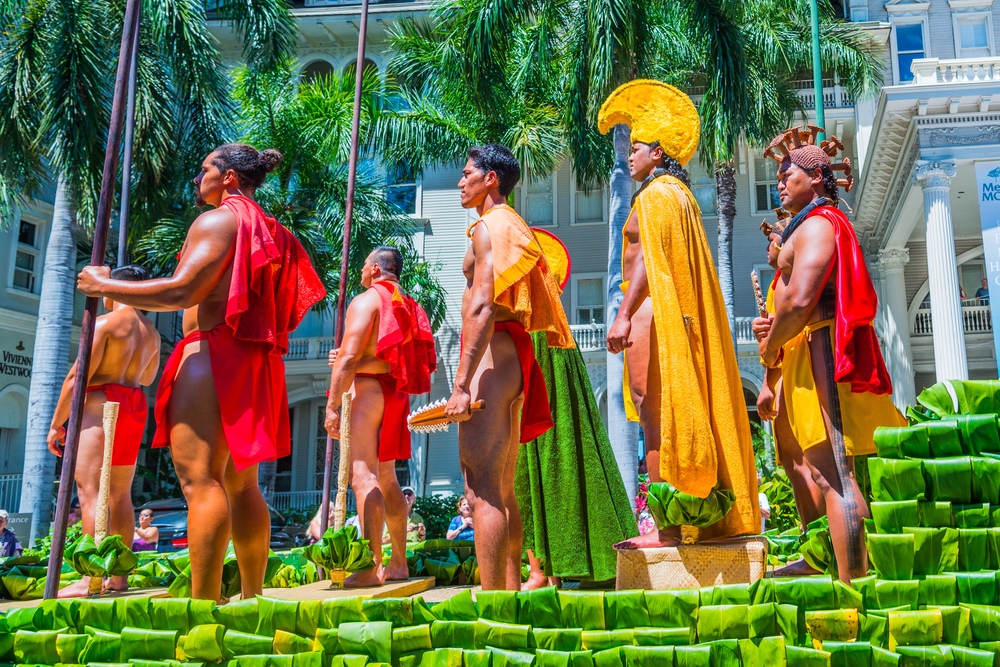 Reenactment of Hawaii's historic events and rulers with people dressed up in traditional clothing and ceremonial wear during the King Kamehameha Day Parade for a piece discussing when did Hawaii become a state