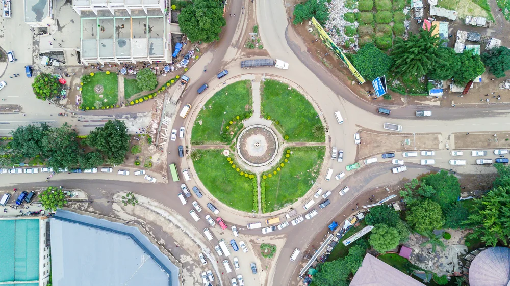 Top view of a town roundabout where cars can be seen running orderly. 