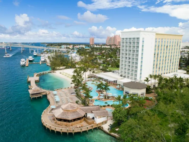 Photo of the Warwick Paradise room tower and pool overlooking the ocean on Paradise Island, one of the best places to stay in the Bahamas