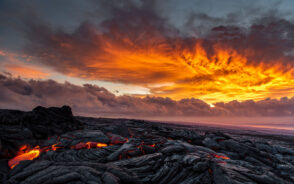 Photo of a lava on the horizon of a sunrise over the southeast rift zone for a guide titled Is Kilauea Safe to Visit