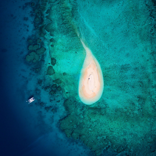 top view of an isolated island where the surrounding water are clear during the best time to visit Fiji.