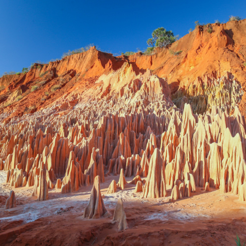 a rock formation on the side of a mountain, where rocks are pointy and has vertical canals, seen during the best time to visit Madagascar.