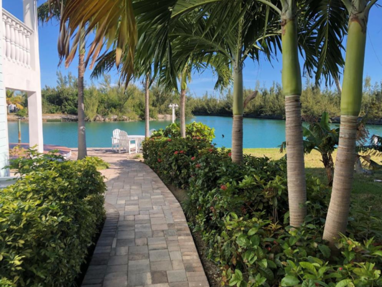 Unique stay at Dolphin Cove, a top pick for where to stay in the Bahamas, with a cool walking path between trees by a pond