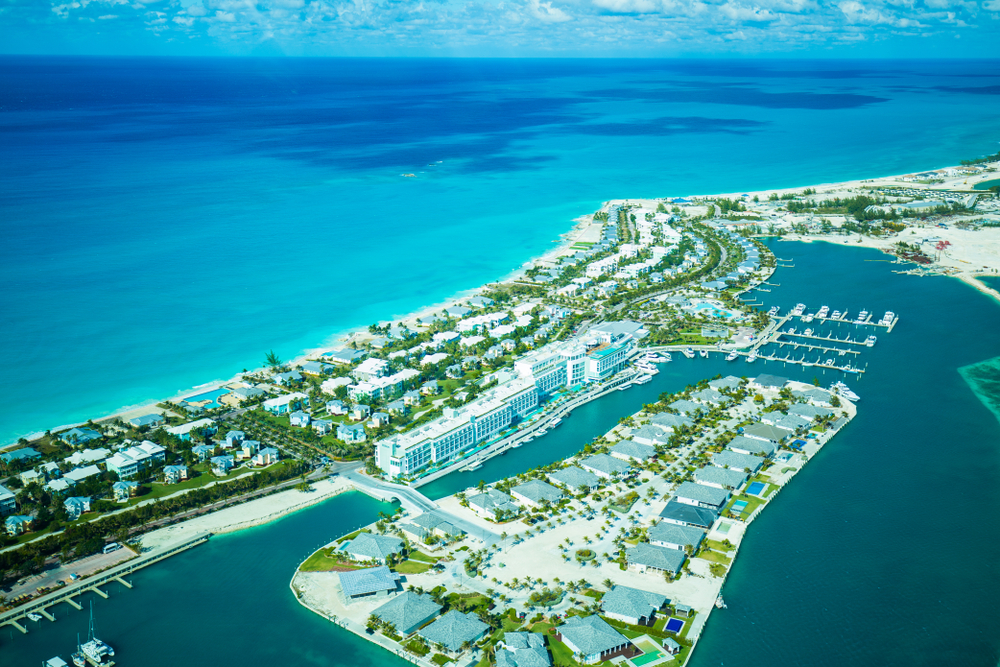 Aerial view of an island with well organized construction of its buildings, and an inviting blue waters. 