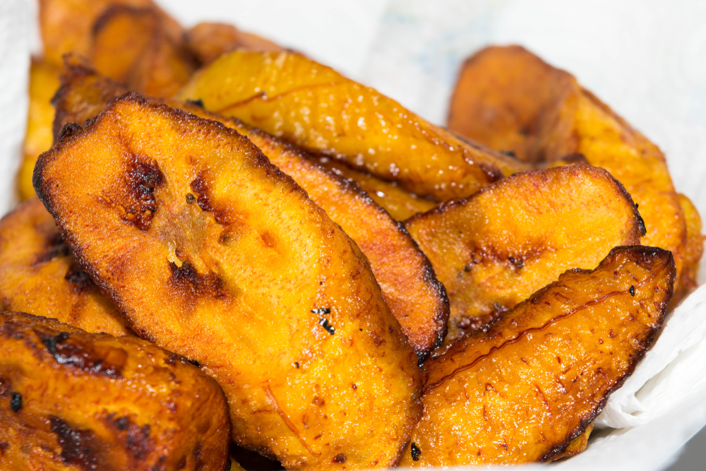 A friend banana dish named Plantains, a Caribbean food, served on a table napkin to absorb the oil.