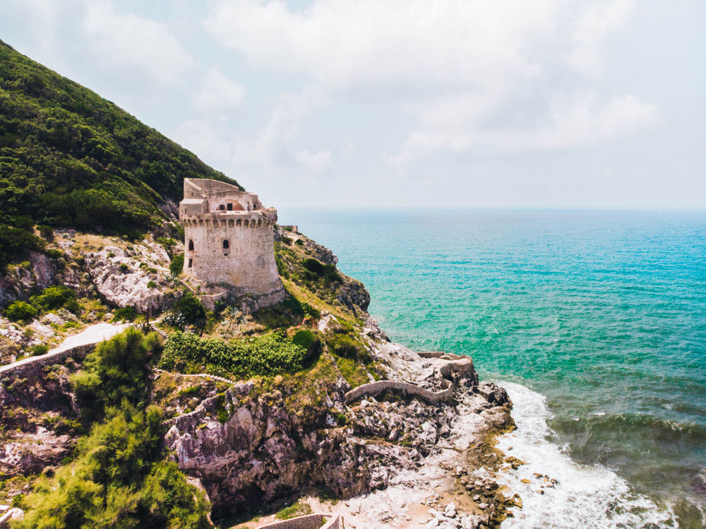 Medieval defense tower crumbling by the sea in Sabaudia, Italy in the Lazio region near Rome makes the list of the best places to visit in Italy