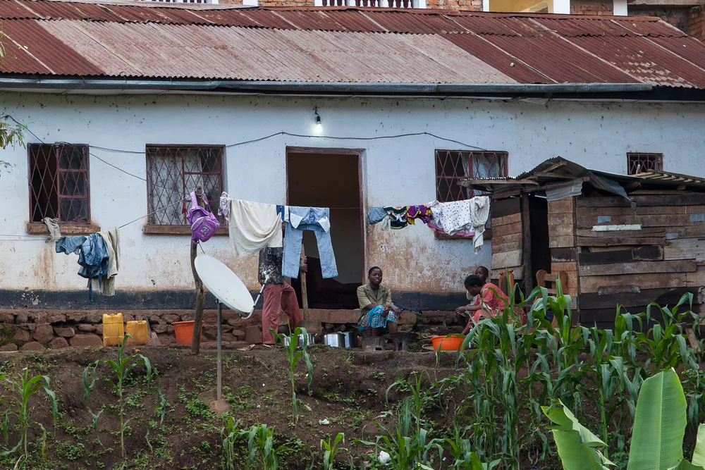 Woman sitting outside her house in Bukavu, one of the places to avoid in Rwanda