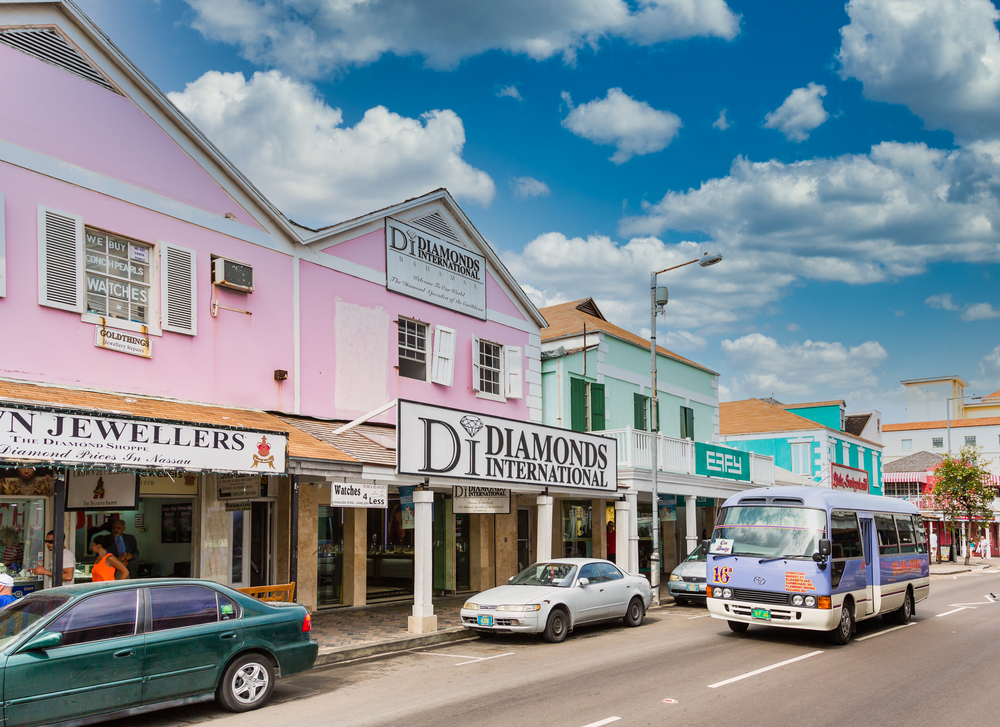 Photo of a bus and a few cars outside of a jewelry shop in Nassau during the cheapest time to visit the Bahamas