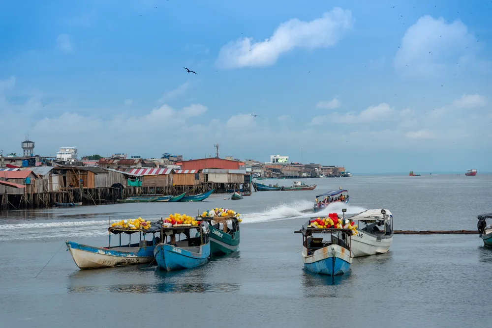 Neat colorful fishing boats pictured in Tumaco for a guide titled Is Colombia Safe to Visit