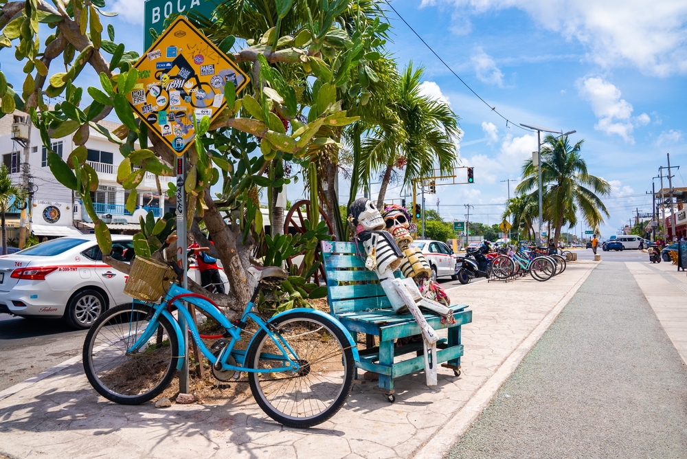 Skeletons and bikes on a bench along the main road in Tulum to show that it's a tourist area and is mostly safe to visit