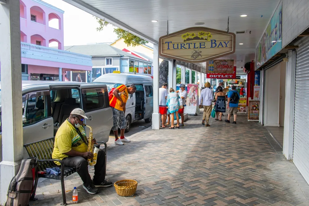 Man playing a saxophone outside on Bay Street in Nassau