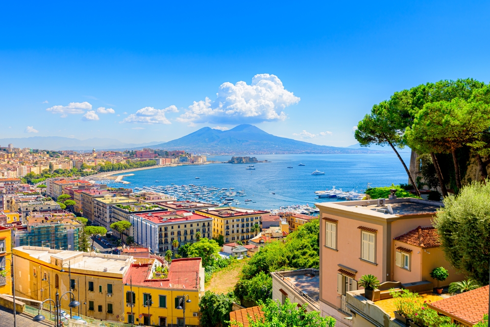 Naples seen from Posillipo Hill with Mount Vesuvius in the distance and old buildings in the foreground indicates why this southern Italian city is great for tourists