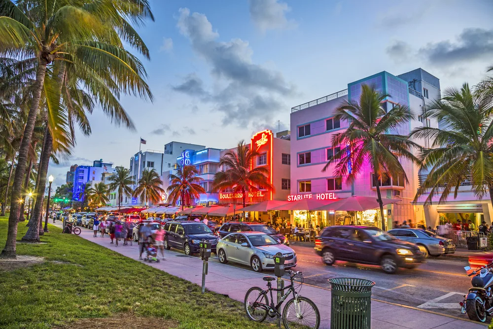 People enjoying the historic and art deco hotels on Ocean Drive in Miami