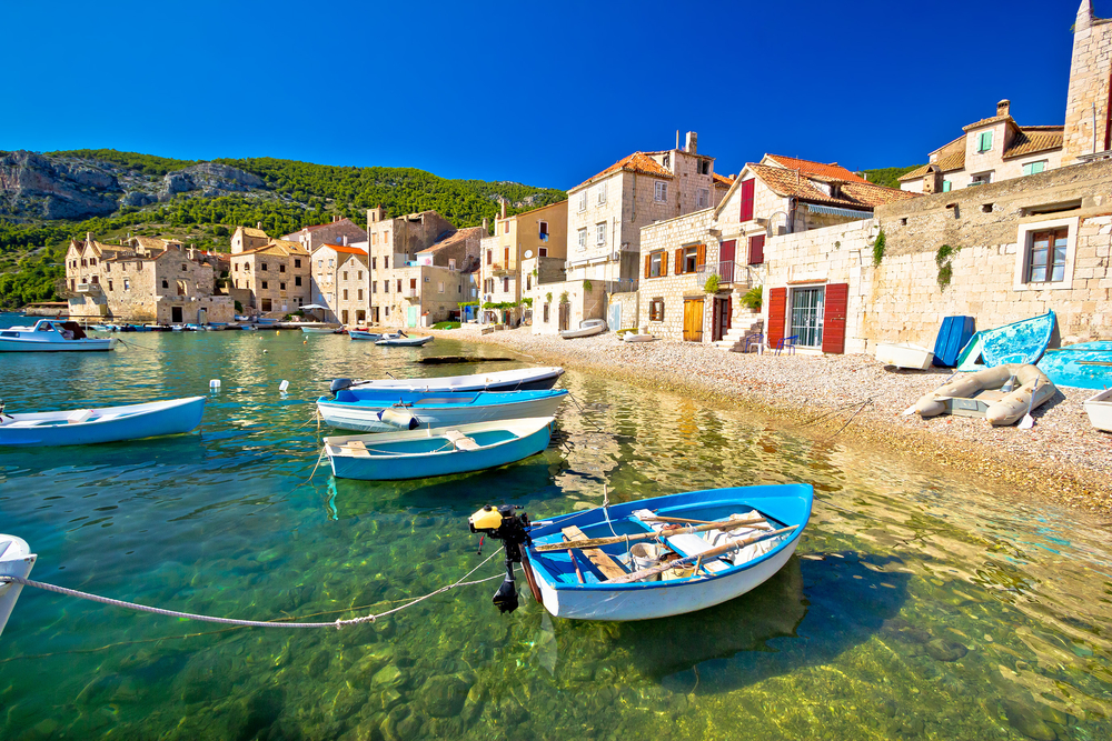 Scenic view of boats floating on the water in Komiza on the island of Vis for a guide to the best times to visit Croatia