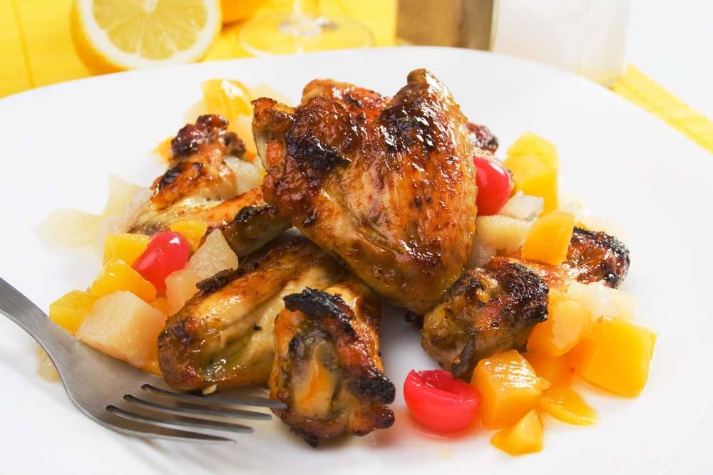Grilled chicken with fruits, a classic display of Caribbean food.