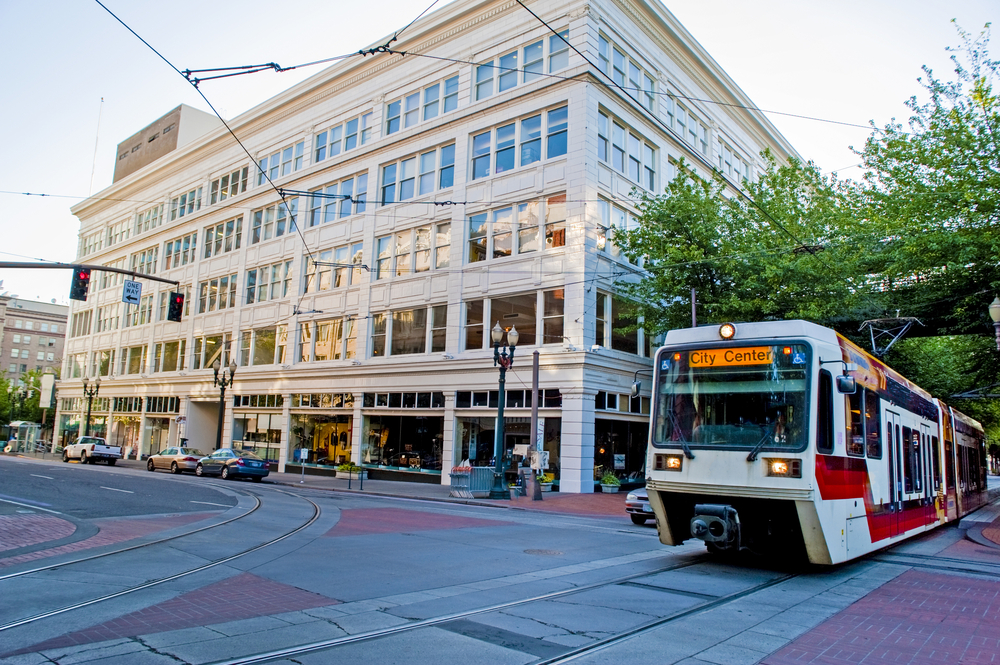 European style streetcar pictured running along the downtown area in Portland for a guide to whether or not the city is safe to visit