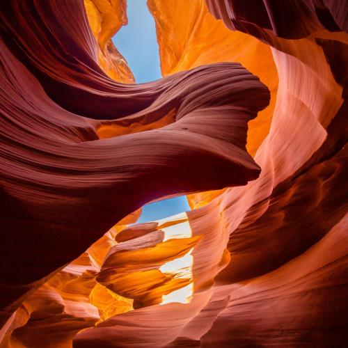a beautiful patterns of rock formation in orange color and the sky is seen at the top in between the spaces of the rocks, seen during the best time to visit Arizona.
