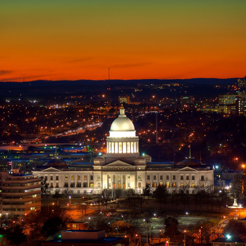 aerial view of a city during dusk of the best time to visit Arkansas where the capitol building is seen and the background is the city.