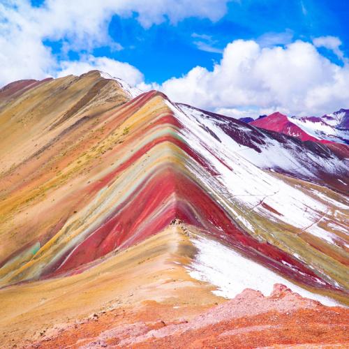 a view of a rainbow mountain during a cloudy afternoon of the best time to visit South America.