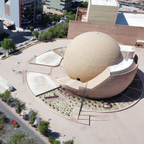 aerial view of a park with a sculpture of a spherical object seen during the best time to visit Tijuana.