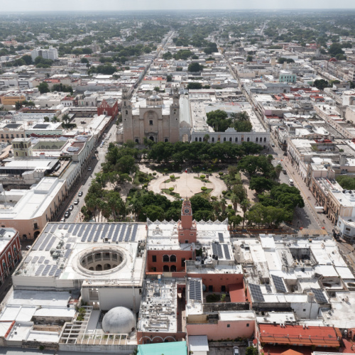 aerial view of a city where a park can be seen on one block during the best time to visit Merida.