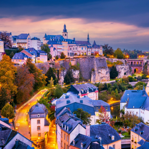 a peaceful dusk in a city where its houses have multiple stories and has roofs made for winter, during the best time to visit Luxembourg.