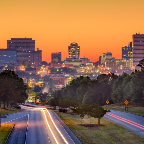 a long exposure photo of a city skyline during a sunset on one of the best time to visit South Carolina.